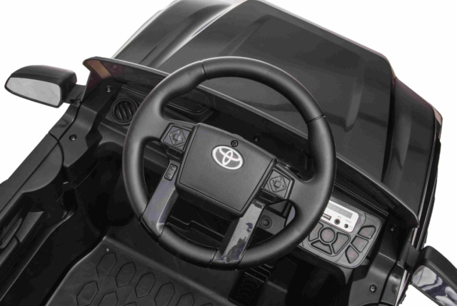 Sort Toyota Tacoma elbil til børn med 2x12V motorer, lædersæde og musikanlæg.